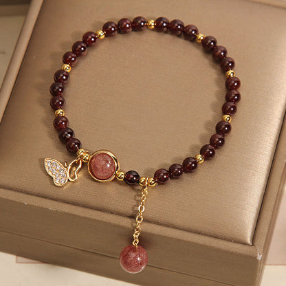 Garnet and butterfly bracelet charm close-up
