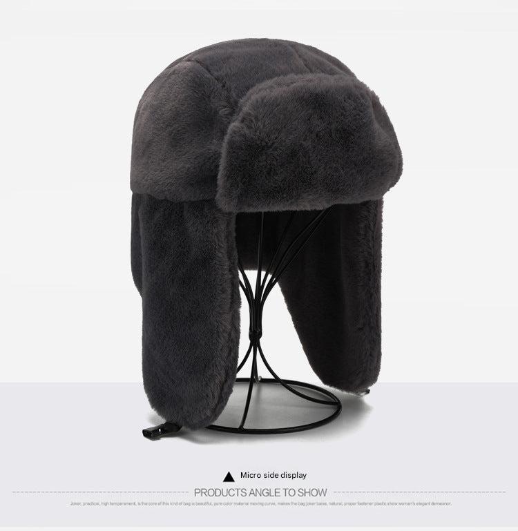 Stylish winter earflap hat on outdoor background