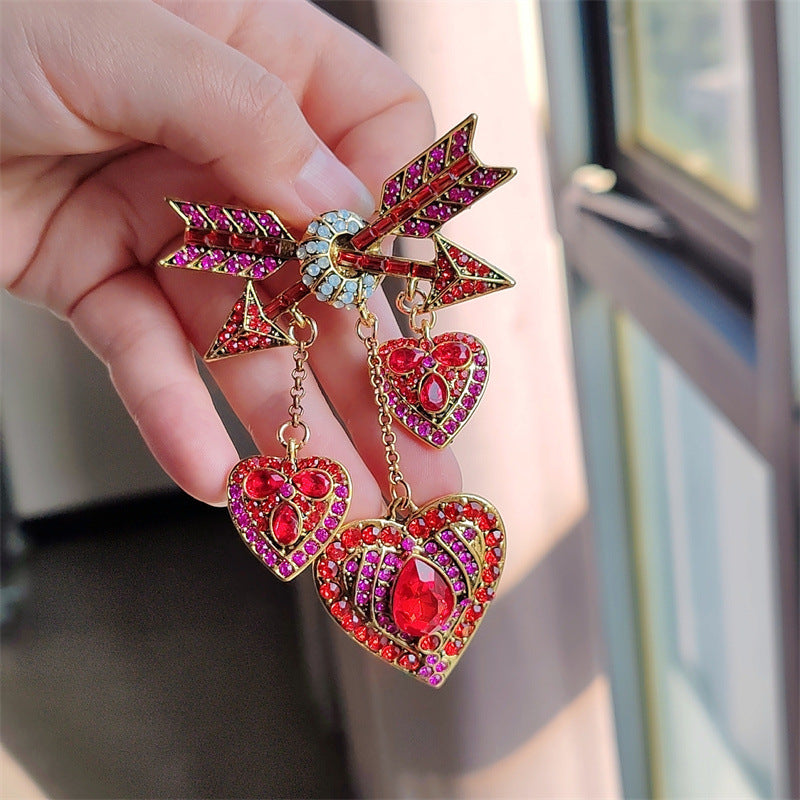Elegant red Cupid arrow pin with stylish design